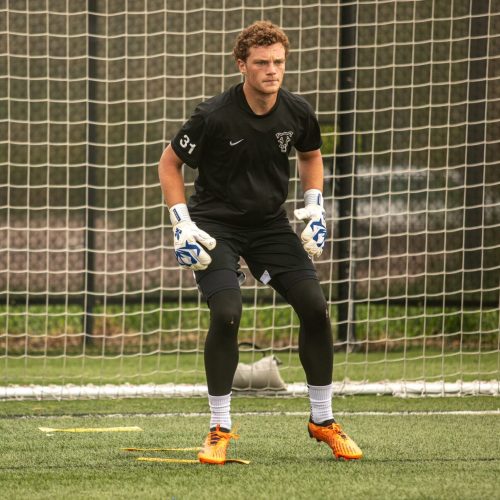 Goalkeeper doing drills while wearing the Fleur De Lis GK Nova Pro OG University Blue Trim.