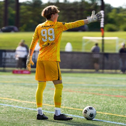 Young Goalkeeper wearing the Fleur de Lis Nova Pros 2.0 Charcoal Trim Gloves.