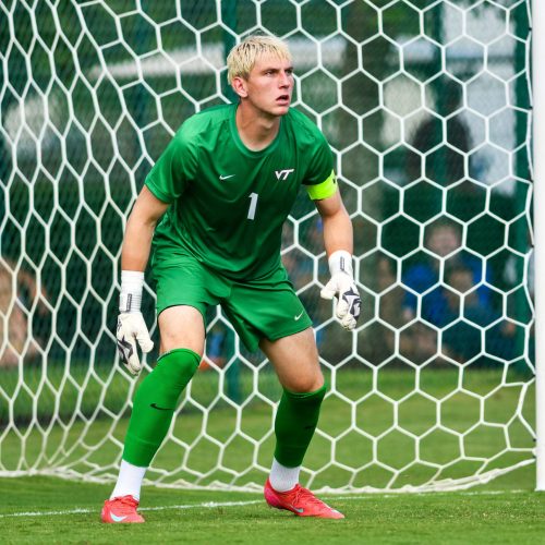 Goalkeeper preparing to make a save while wearing Fleur de Lis GK gloves.